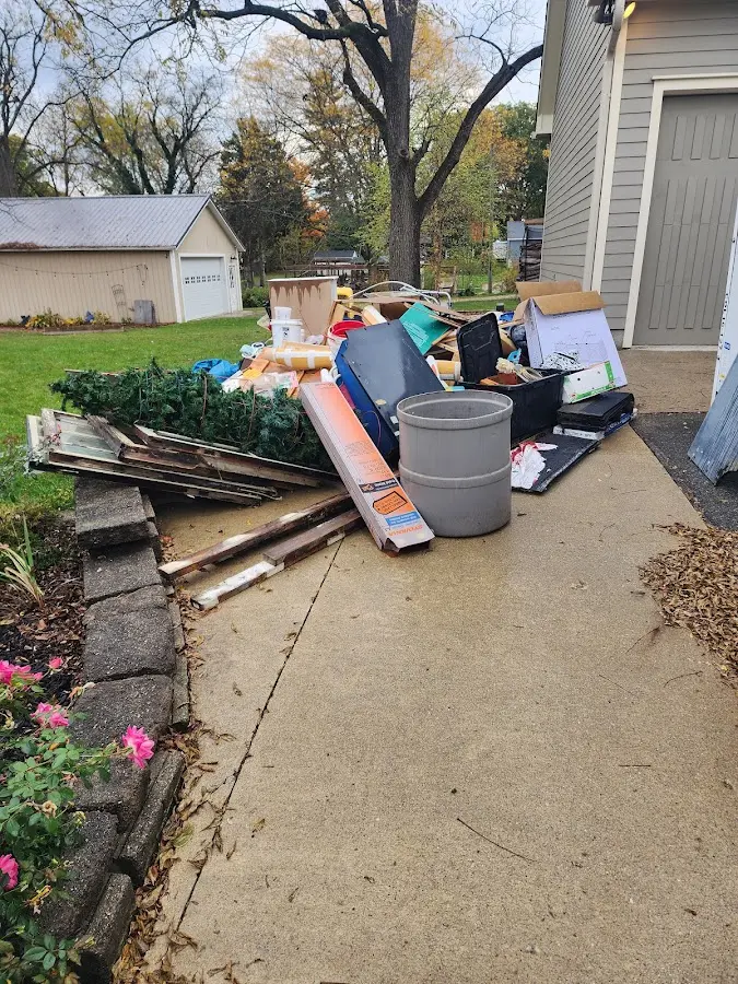 Dumpster being loaded with debris for Demolition Dumpster Rental in West Clarkston-Highland